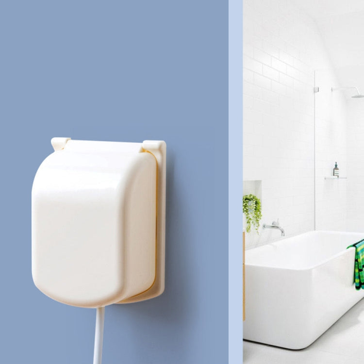 Beige outlet plug cover mounted on wall, covering receptacle with cord inserted