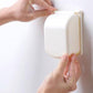 Beige outlet safety cover being fitted by hands over power socket