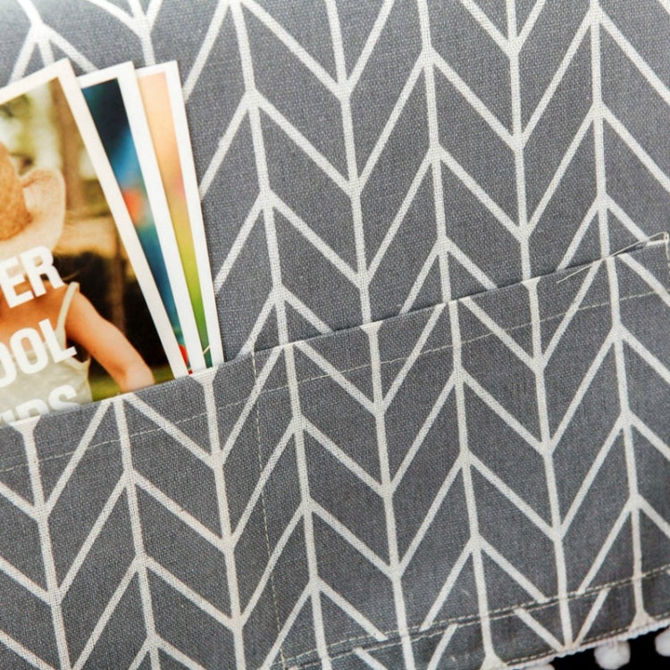 Folded microwave dust cover fabric in dark gray with white arrow pattern, pom trim edge