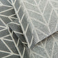 Textile close-up of microwave dust cover with dark gray and white arrow pattern