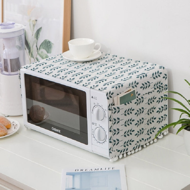 Microwave oven dust cover with white fabric and green leafy sprig print, pom trim