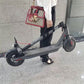 Black scooter handle strap held by person while carrying
