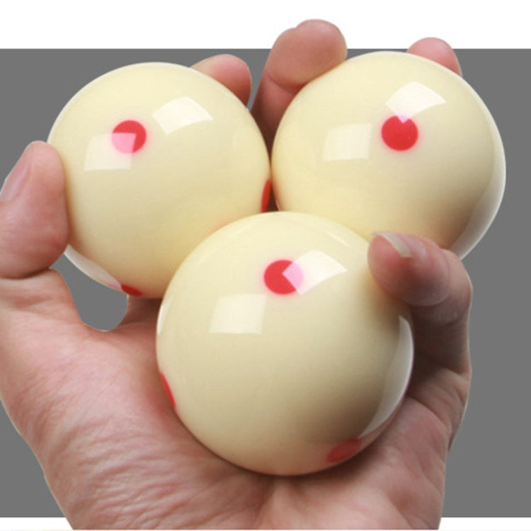 Set of three cream training billiard balls with red dots, held in hands