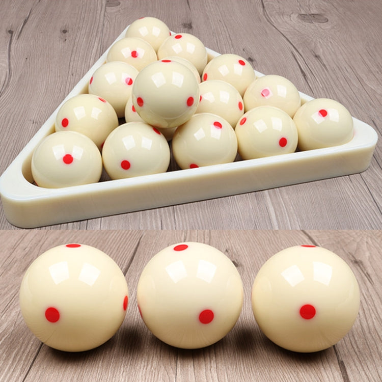 Tray of cream training billiard balls with red dots, with three balls on floor
