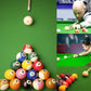 Cream billiard balls with red dots on green table during practice