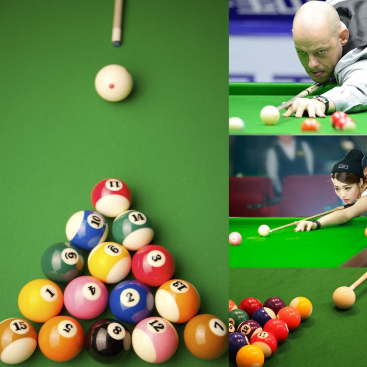 Cream billiard balls with red dots on green table during practice