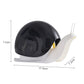 Snail-shaped hand sanitizer dispenser with black shell dome and white base, twin nozzles