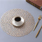 Gold-toned round PVC lace placemat with intricate openwork mesh