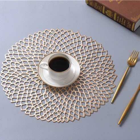 Gold-toned round PVC lace placemat with intricate openwork mesh
