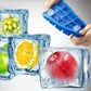 Blue 15-grid silicone ice tray with square fruit ice cubes, being held