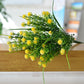 Yellow artificial starry flower spray with clustered blossoms on green stems