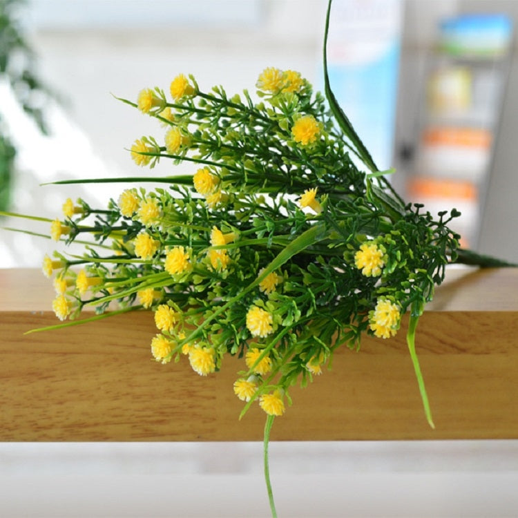 Yellow artificial starry flower spray with clustered blossoms on green stems