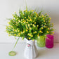 Yellow simulation flower bouquet in a white textured vase with decorative lid detail