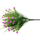 Purple artificial flower spray with small clustered blossoms and green stems