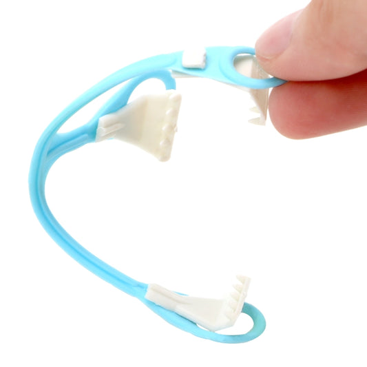 Blue plastic three-hook diaper buckle clip with small claw prongs held by fingers