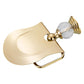 Gold toilet paper roll holder with curved metal bar and clear crystal handle
