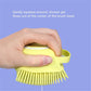 Hand squeezes gel into yellow pet bath brush head with dense bristles