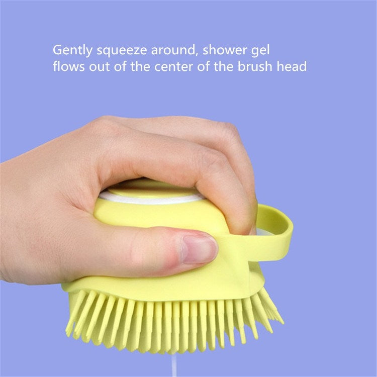Hand squeezes gel into yellow pet bath brush head with dense bristles