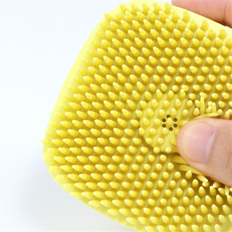 Close-up of yellow silicone nubs on pet bath massage brush
