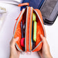 Orange nylon pencil case opened to show two zip compartments and holders