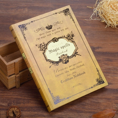 Yellow vintage pocket notebook, full cover view with gold-toned spell design and frame.