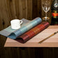 Set of 2 table cup mats rolled up, light blue and red/burgundy woven texture