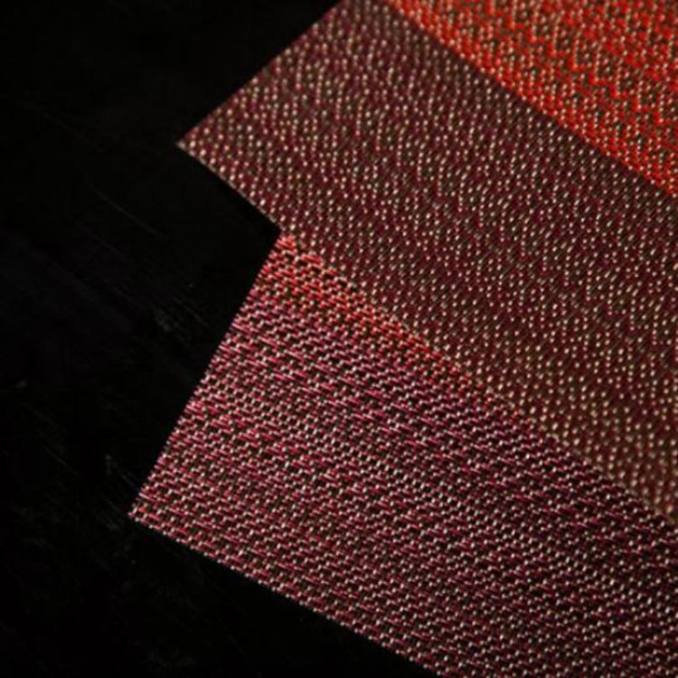 Close-up of burgundy red textured table cup mat fabric weave