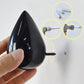 Black resin water droplet wall hook with mounting screw and hardware close-up