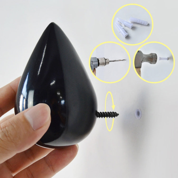 Black resin water droplet wall hook with mounting screw and hardware close-up