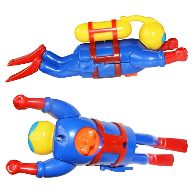 Clockwork diver toy with yellow helmet, blue body, red fins and red hand flippers