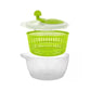 Salad spinner with green basket and clear lid, plus white collection bowl