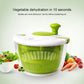 Compact salad spinner with green basket and white lid knob for drying greens