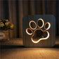Wooden LED night lamp with glowing large paw print outline on the front