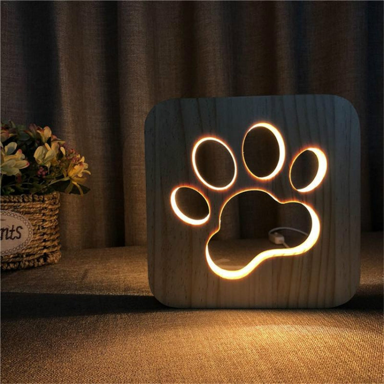 Wooden LED night lamp with glowing large paw print outline on the front