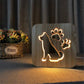 Wooden LED night lamp with glowing dog silhouette and paw print icons on wood