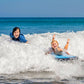 Inflatable bodyboard in ocean waves, blue with bright yellow and pink graphics