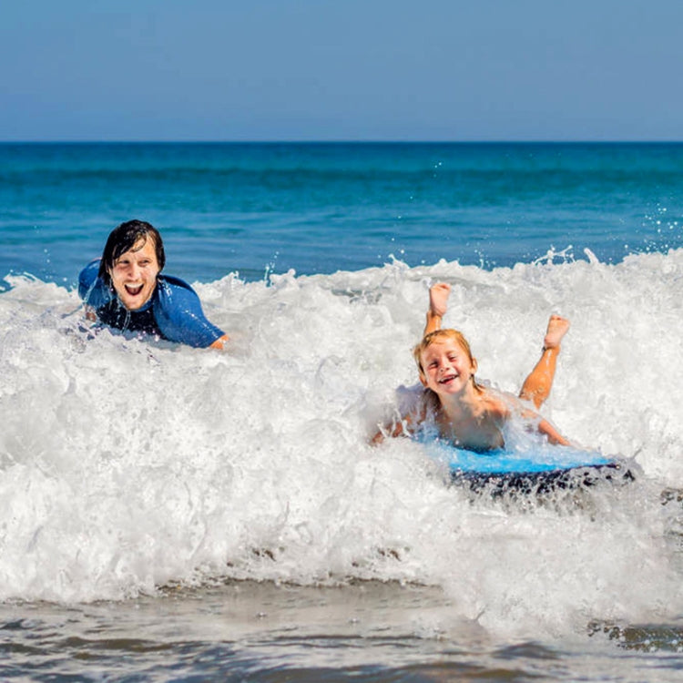 Inflatable bodyboard in ocean waves, blue with bright yellow and pink graphics
