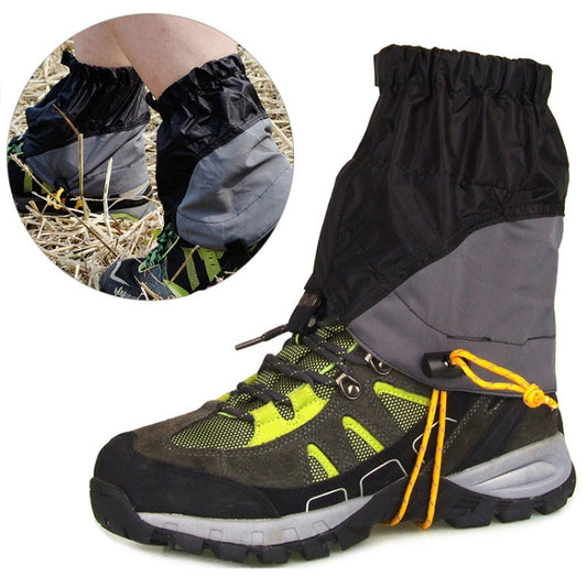 Black outdoor waterproof legging covers with drawstring closure over hiking shoes