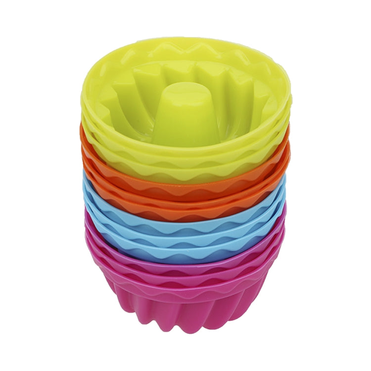 Stack of multicolor silicone thread-shaped baking molds, round pudding cups