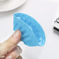 Hand holding a blue silicone thread-shaped baking mold cup