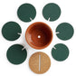 Top view of cactus coaster: orange pot with cork pad and 6 green cactus leaf pieces.
