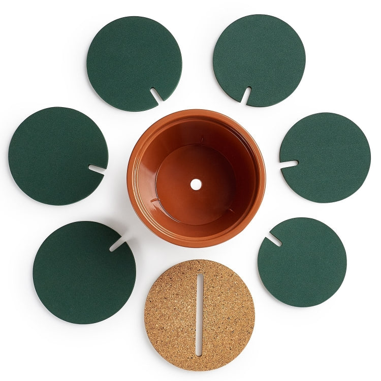 Top view of cactus coaster: orange pot with cork pad and 6 green cactus leaf pieces.