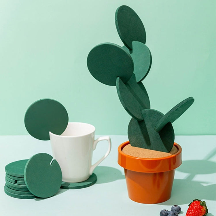 Cactus coaster under a white mug: green felt cactus on cork in an orange pot.