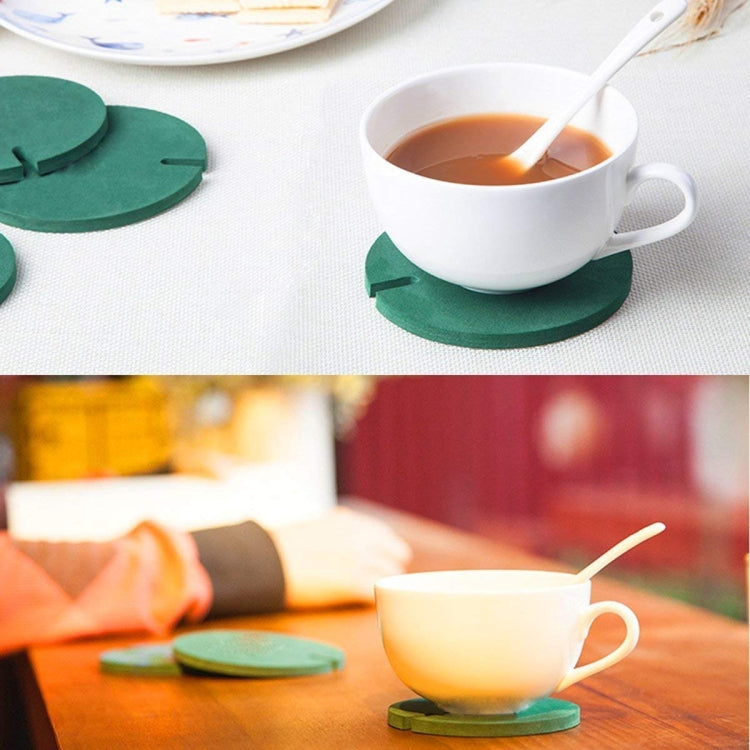 Tea cup on cactus coaster: green felt cactus pieces on cork pad with orange pot.