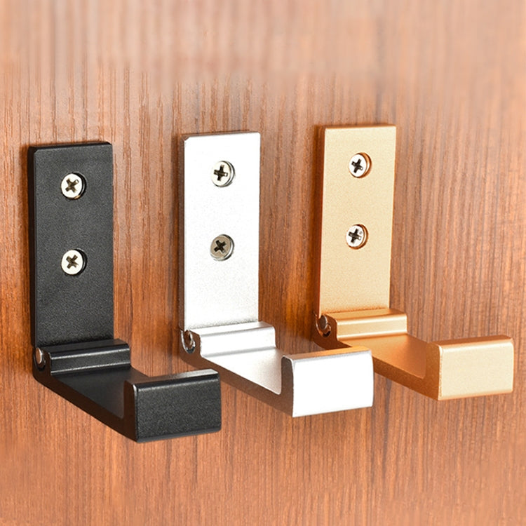 Black wall-mounted folding robe hook with two screws on wooden wall panel