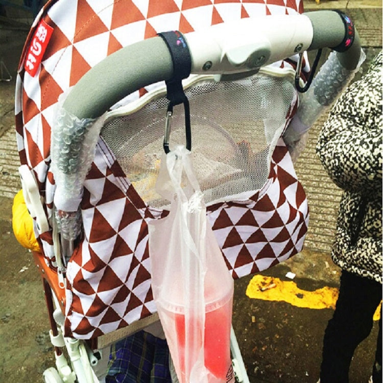 Black stroller hook attached to stroller frame with fabric strap and metal clip