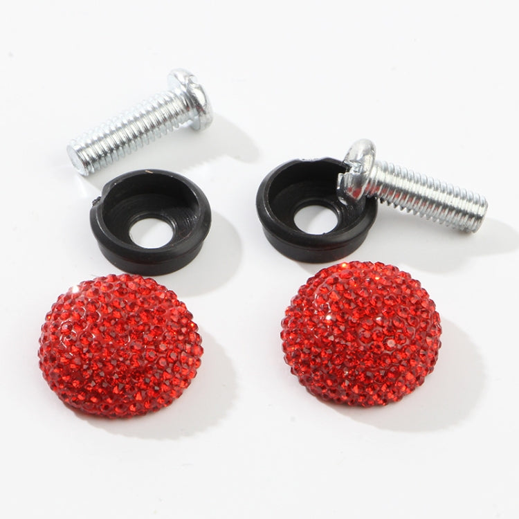 Two red crystal screw caps with chrome anti-theft screws and black rubber grommets