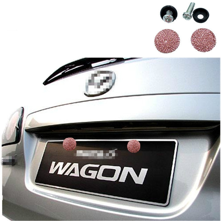 Red rhinestone screw caps installed on a car license plate panel