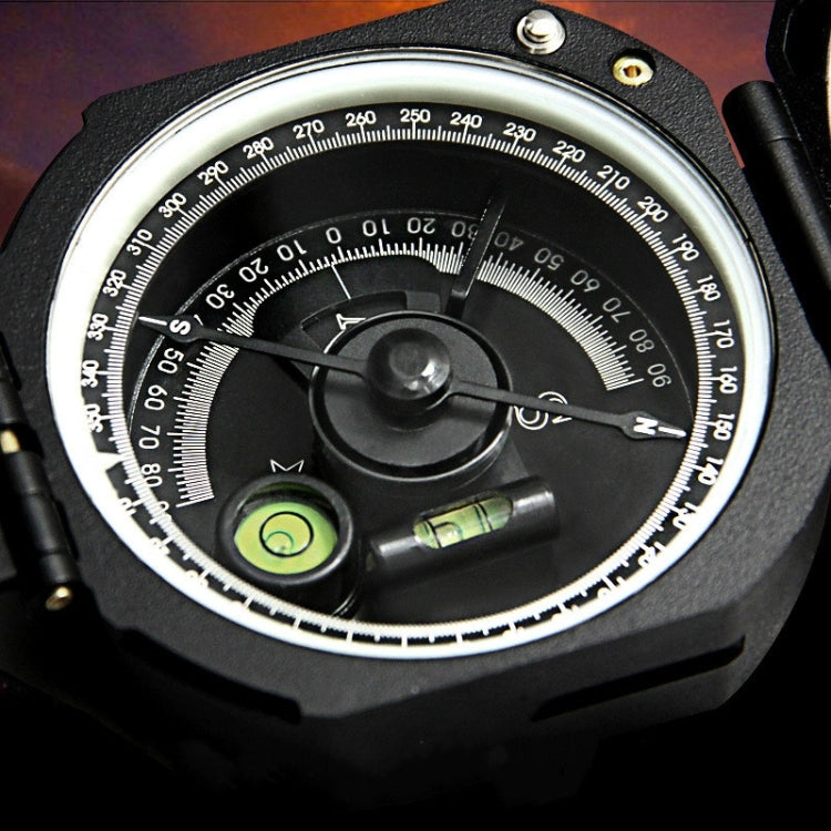 Compass dial close-up with degree markings, central needle, and green indicator lens