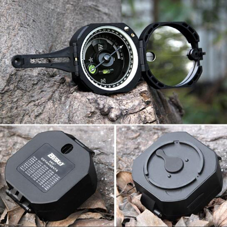 Outdoor flip compass on rock with open dial window and protective cover